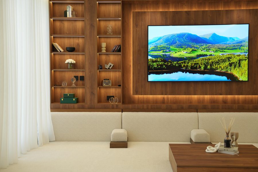 Majlis with a walnut TV wall and lit shelving