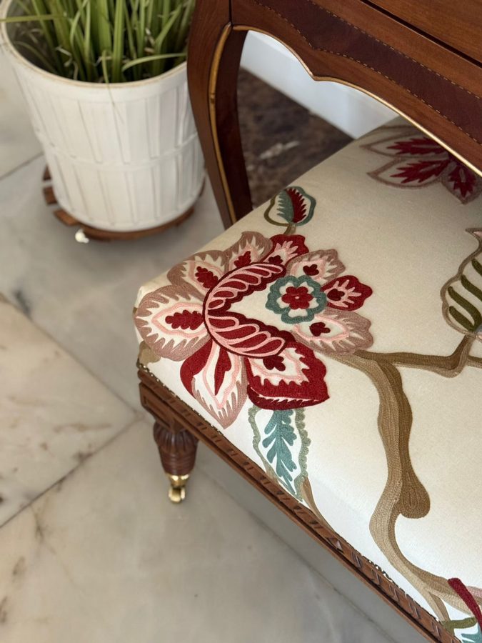 Carved chair with floral embroidered upholstery