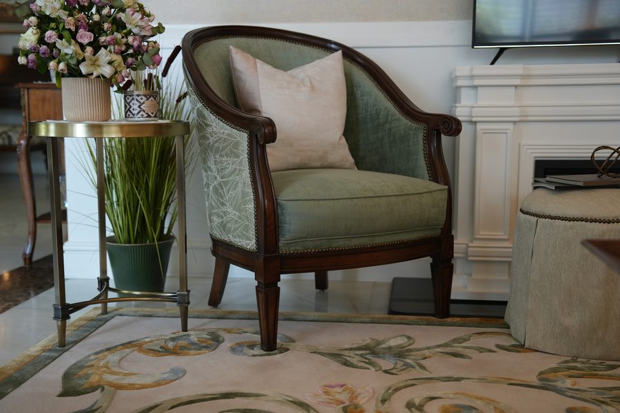 Sage armchair with a carved frame