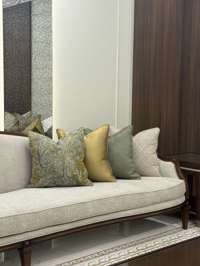 Ivory sofa with green and gold cushions