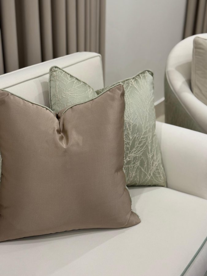 Satin cushions on an ivory sofa