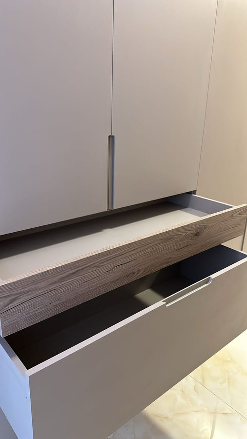 Handleless wardrobe with a walnut drawer