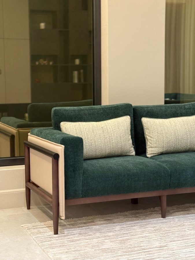 Green velvet sofa with cane side panels