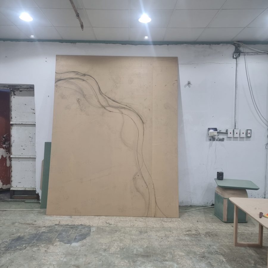 The timber feature wall mid-installation, with its drawn line