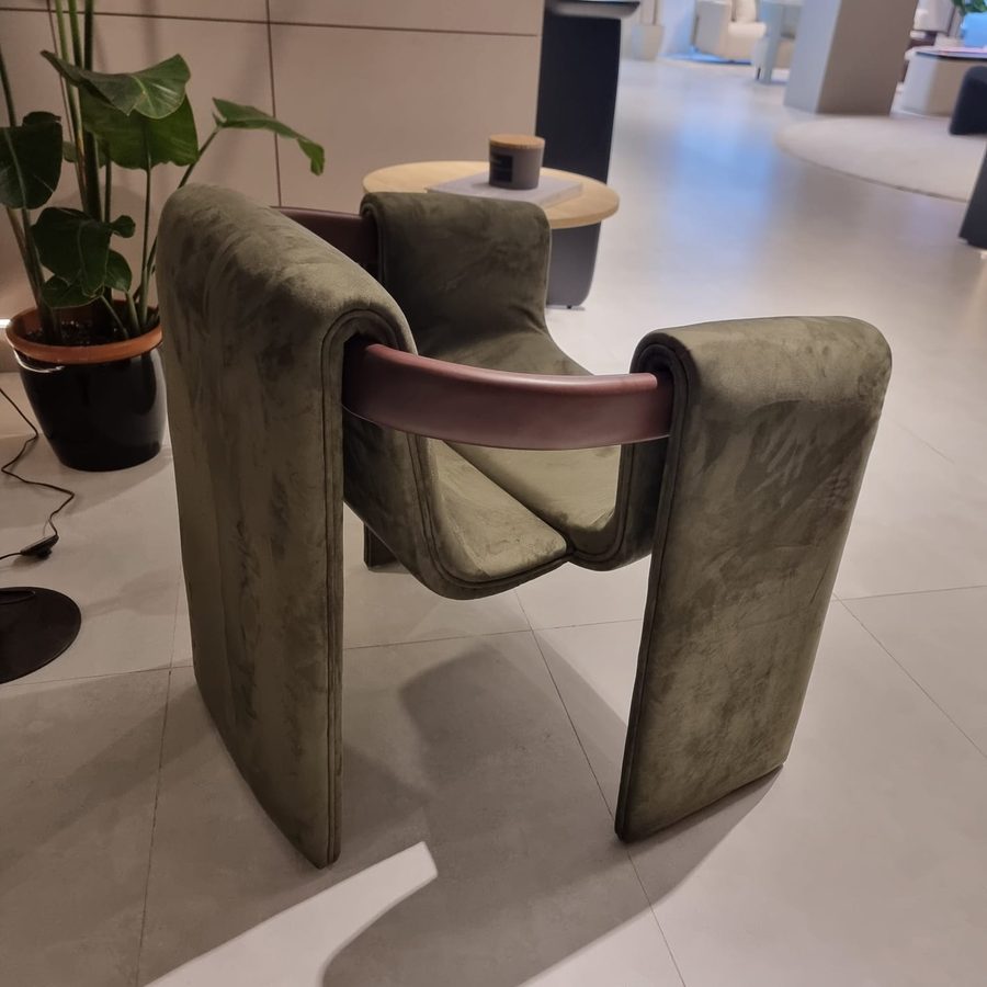 Sculptural armchair in olive bouclé