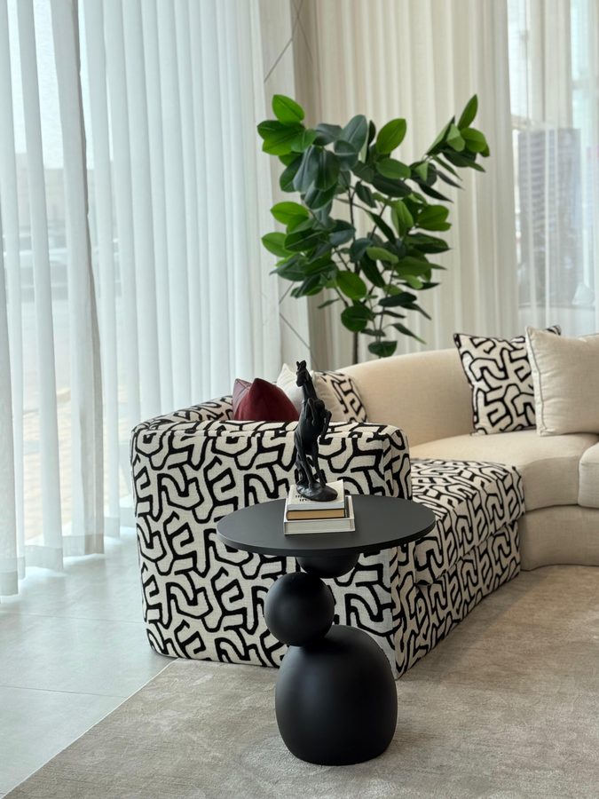 Patterned armchair beside a fiddle-leaf fig