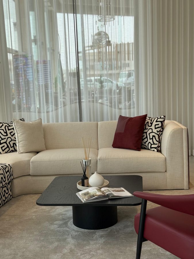 Cream sofa with monochrome and burgundy cushions