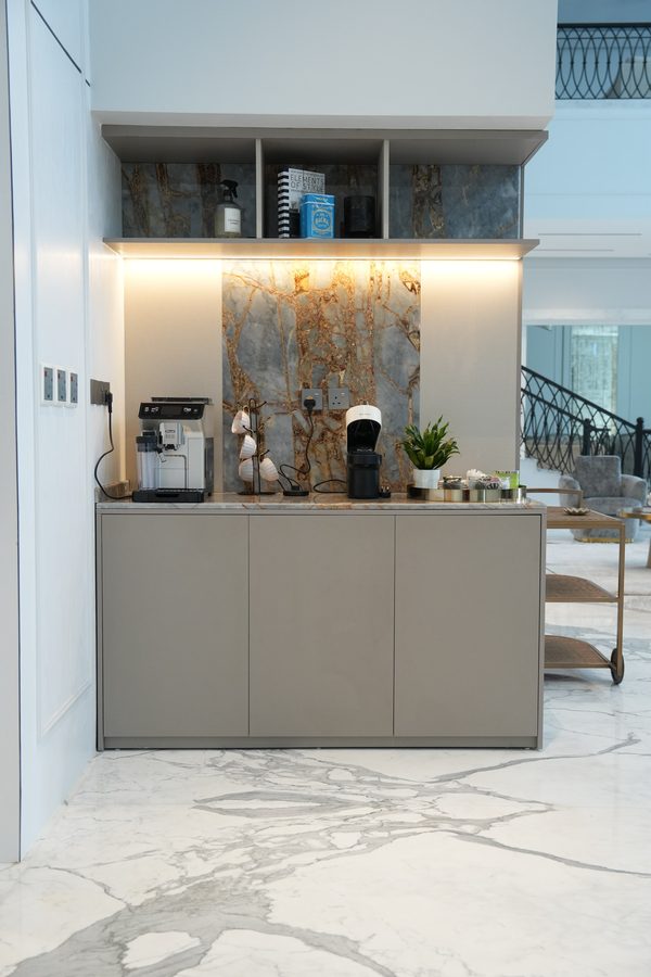 Coffee station with a marble backsplash and stone-grey cabinetry