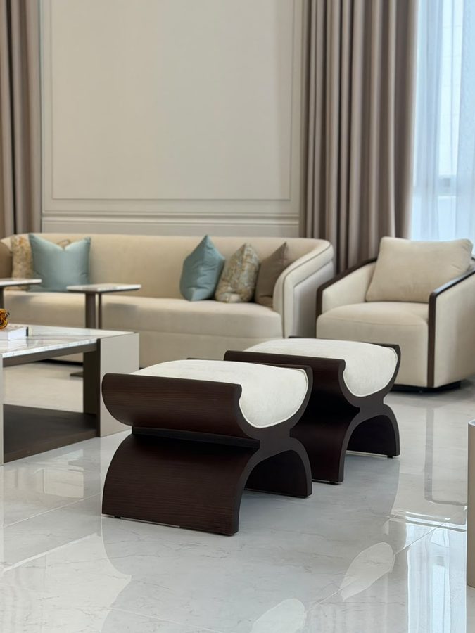 Curved walnut-and-cream ottomans