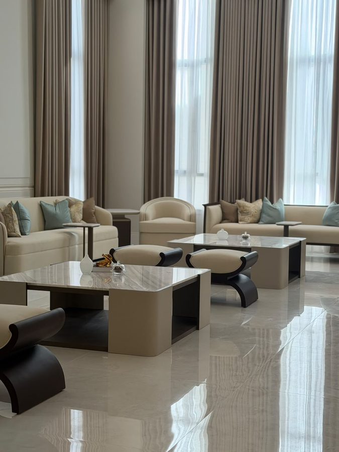 Majlis with double-height curtains and nested tables