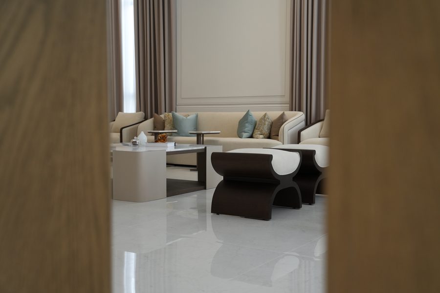 Living room framed through walnut doors