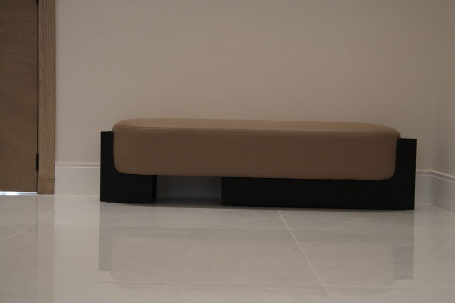 Low upholstered bench on a black base