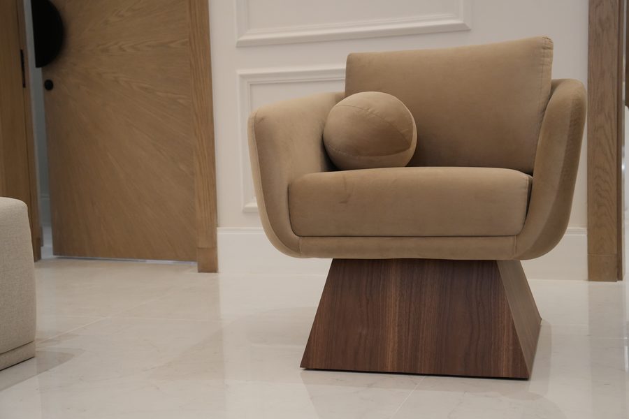 Taupe armchair on a faceted walnut base