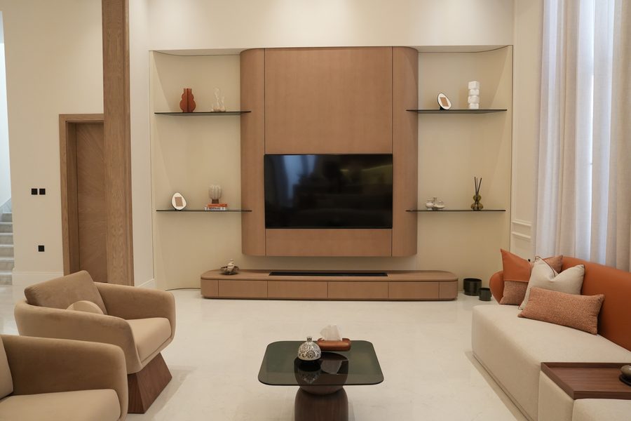 Living room with a walnut TV wall and open shelving