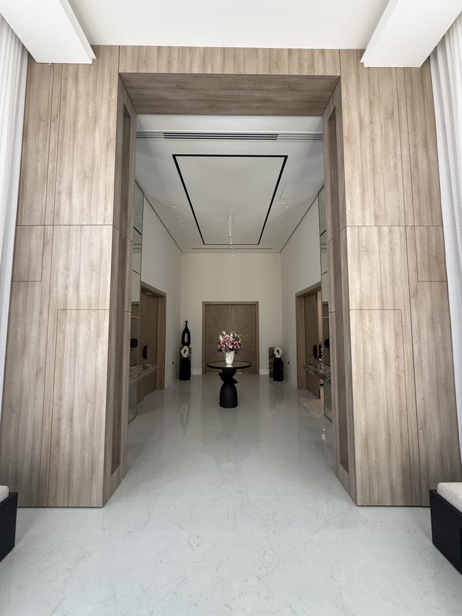 Entrance corridor framed in timber panelling